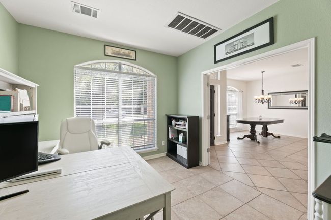 Office with a chandelier and light tile patterned flooring | Image 5