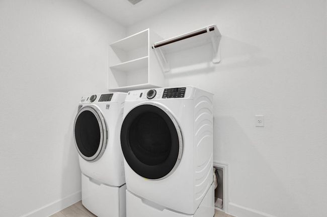 Washroom with washer and dryer and baseboards | Image 38