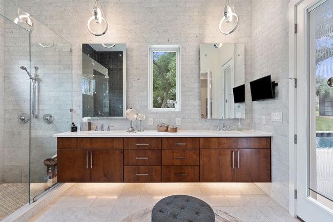 The primary bath blends calming tones with bold design for an indulgent experience. | Image 9