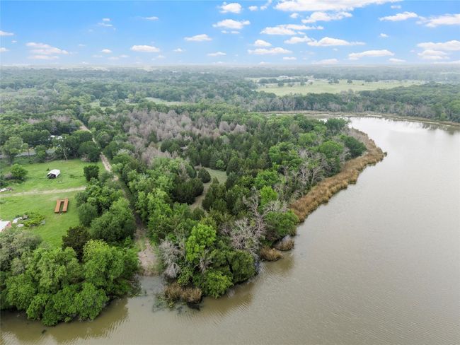 Birds eye view of property with a water view and a view of trees | Image 11