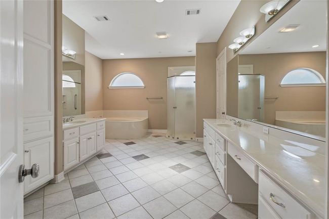 Primary bathroom has two huge, separate vanities and closets, a laundry shoot to the laundry room next door, a built in safe - very thought out and functional space. | Image 22