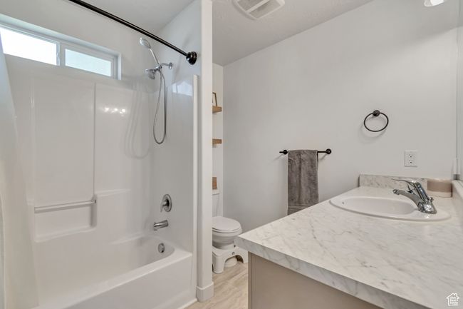 Full bath featuring vanity and shower / bath combination | Image 13