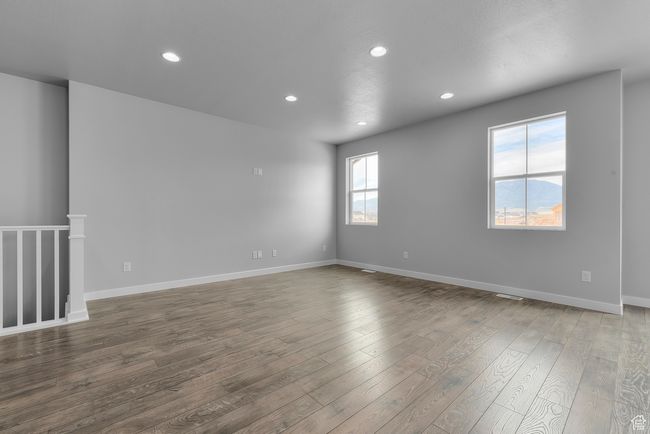 Unfurnished room featuring dark wood-style floors and recessed lighting | Image 14