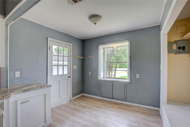 Entryway with light wood-style floors, crown molding, and baseboards | Image 8