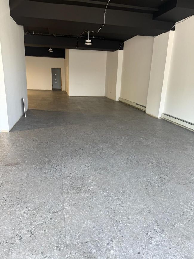 Garage with a garage door opener and a baseboard heating unit | Image 4