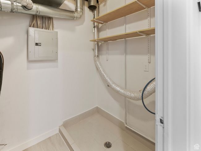 Washroom with electric panel and baseboards | Image 23