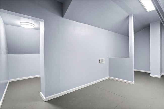 Bonus room with finished concrete floors, lofted ceiling, and baseboards | Image 31