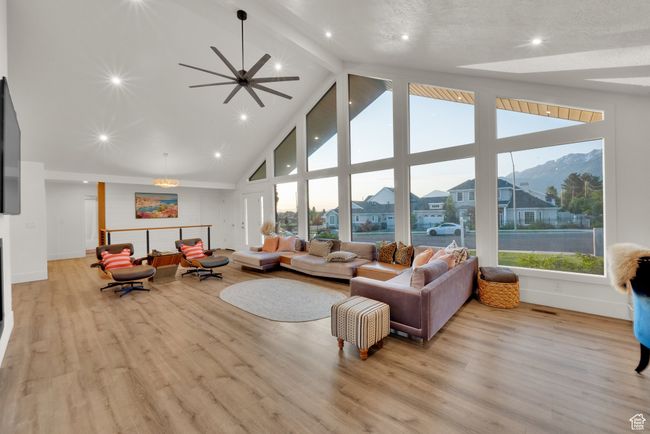 Living room featuring high vaulted ceiling, beamed ceiling, light wood-style floors, and baseboards | Image 11