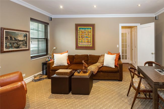 Living area featuring ornamental molding, light colored carpet, and recessed lighting | Image 9