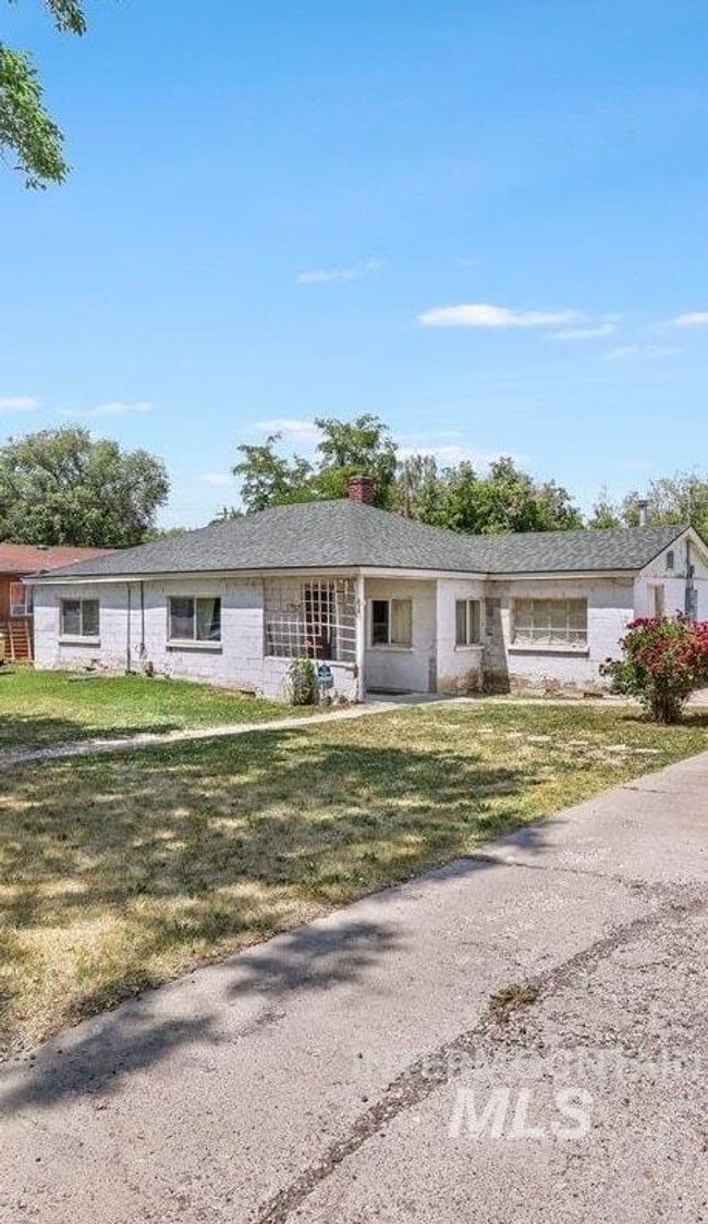View of front of property with a front yard, gravel driveway, and a chimney | Image 4