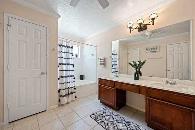 Primary bedroom bathroom with 2 huge his and her walk-in closets | Image 24