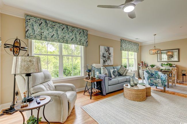 Living room with light wood-type flooring, ceiling fan, and ornamental​​‌​​​​‌​​‌‌​‌‌​​​‌‌​​‌‌​‌​​​​​‌ molding | Image 12