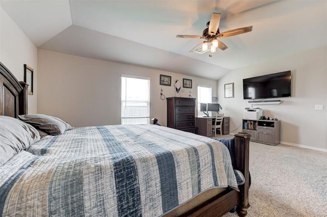 Bedroom with vaulted ceiling, carpet flooring, and a ceiling fan | Image 21