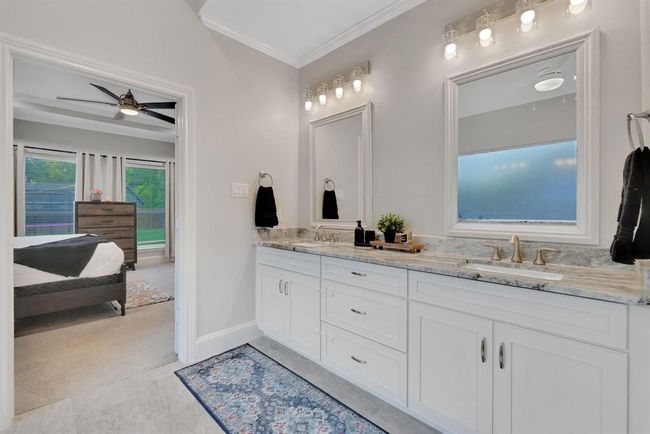 Thoughtfully designed with dual sinks, the primary bath ensures comfort and ease for shared living. | Image 26