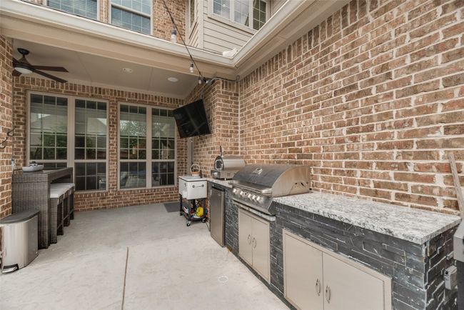 View of patio with an outdoor kitchen and ceiling fan | Image 31