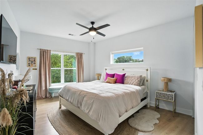 Bedroom with light wood-type flooring and a ceiling fan | Image 14