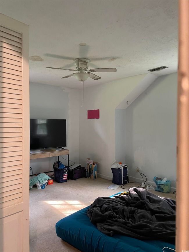 Carpeted bedroom featuring ceiling fan | Image 33