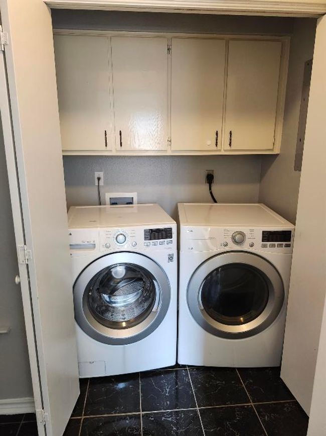 Washroom featuring washer and dryer and cabinet space | Image 7