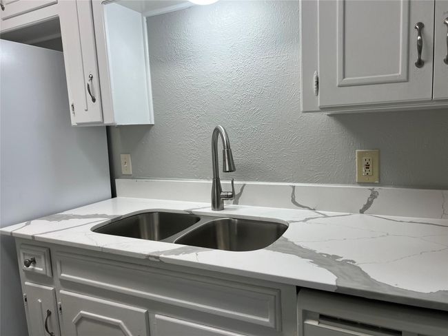 Kitchen featuring dishwasher, gray cabinetry, and light stone countertops | Image 9