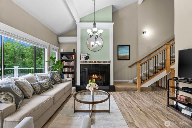 Living room looking towards main floor entrance hallway and stairwell to 2nd floor | Image 9