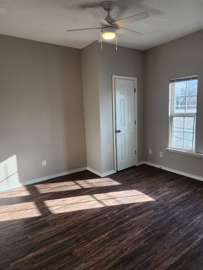 Unfurnished room with baseboards, dark wood-style floors, and ceiling fan | Image 10