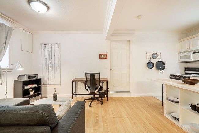 Living room with light wood-style flooring and ornamental molding | Image 28