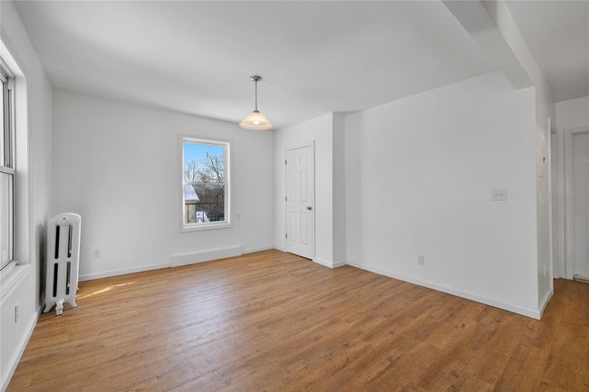 Empty room with radiator heating unit and light hardwood / wood-style flooring | Image 14