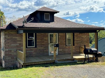 Rear view of house featuring a wooden deck | Image 1