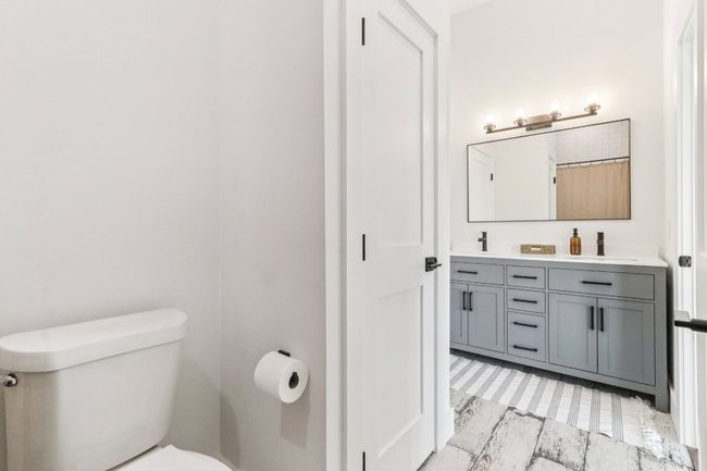 Bathroom featuring double vanity and toilet | Image 16