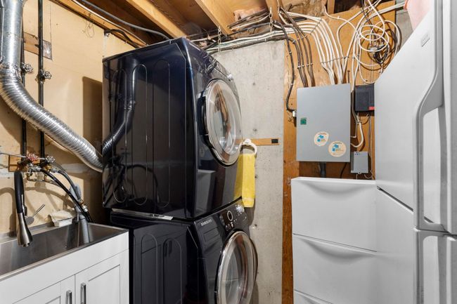 Laundry room featuring stacked washer / dryer | Image 32