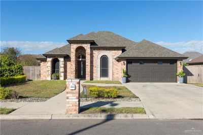 View of front of home with a front lawn and a garage | Image 1