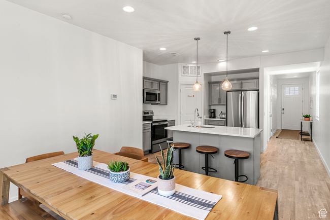 Dining space with recessed lighting, visible vents, light wood-type flooring, and baseboards | Image 11