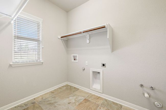 Clothes washing area featuring baseboards, gas dryer hookup, laundry area, and washer hookup | Image 27