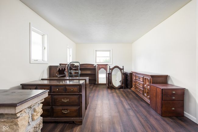 office area with dark wood-type flooring and a textured ceiling | Image 7