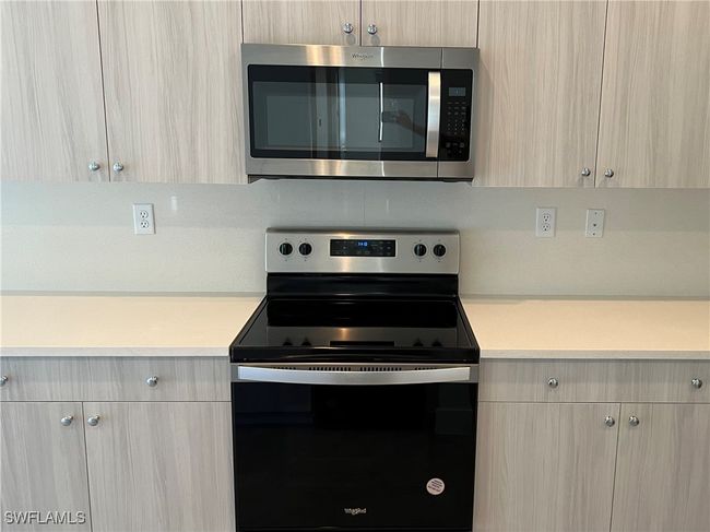 Kitchen featuring light brown cabinetry and stainless steel appliances | Image 14