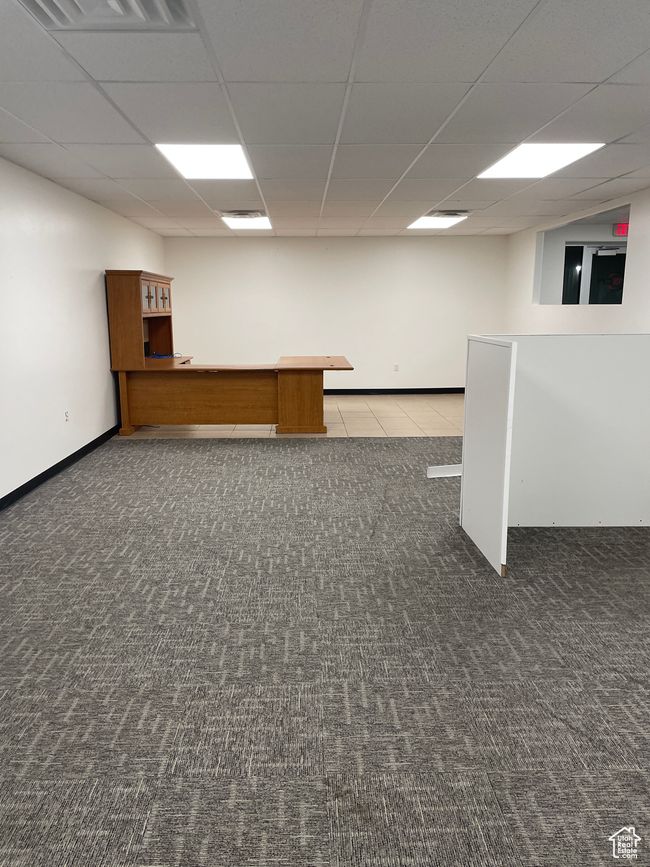 Finished basement with baseboards, visible vents, carpet floors, and a drop ceiling | Image 10