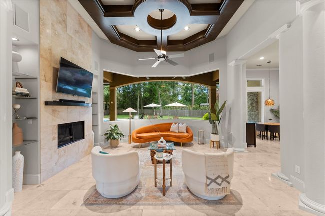 Enjoy uninterrupted views and effortless indoor-outdoor living with a wall of windows that opens to the backyard oasis | Image 13