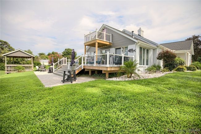 Back of house with a yard, a wooden deck, a balcony, a gazebo, and a patio | Image 23
