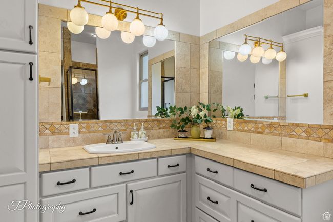 Bathroom with tasteful backsplash, vanity, and a stall shower | Image 36