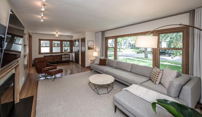 Living room features hardwood floors & lots of windows to let the light in. | Image 8