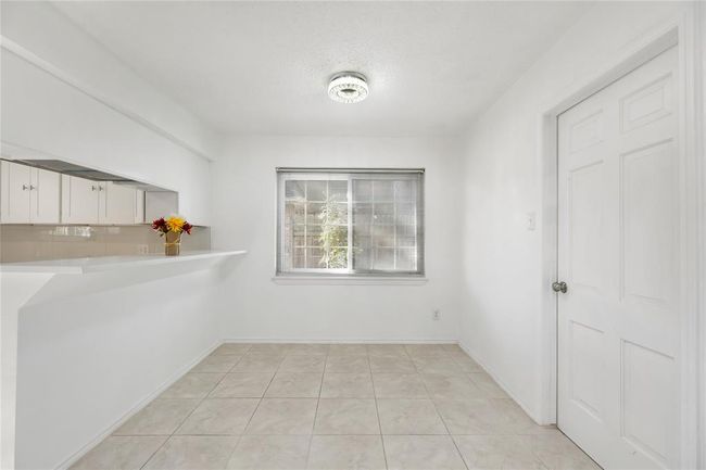 Dining room, showing high top bar to the left, and laundry to the right | Image 21