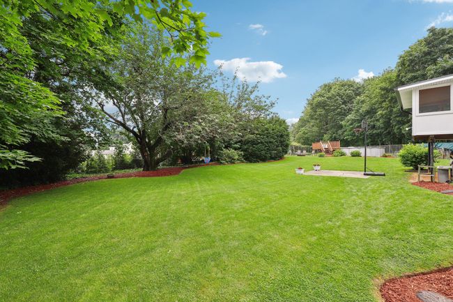 Back of house with a patio, a sunroom, stairs, and a chimney | Image 29