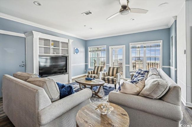 Living area with ornamental molding, ceiling fan, recessed lighting, and wood finished floors | Image 4
