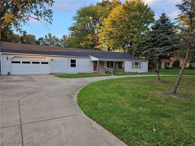 Single story home featuring a garage, a porch, and a front lawn | Image 2