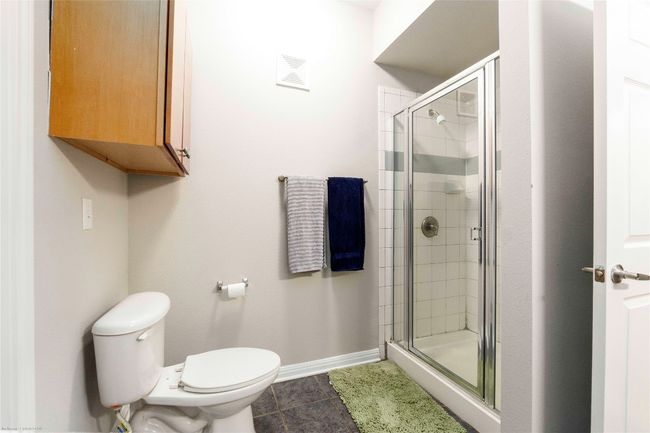 Bathroom with a stall shower and tile patterned flooring | Image 16