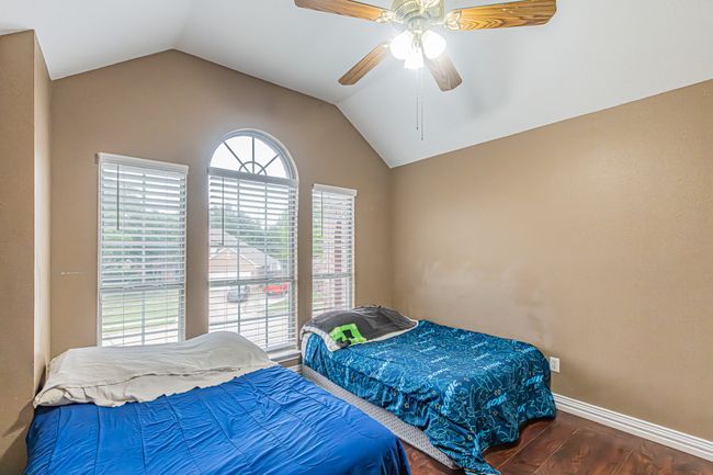 Bedroom with wood finished floors, vaulted ceiling, and ceiling fan | Image 31