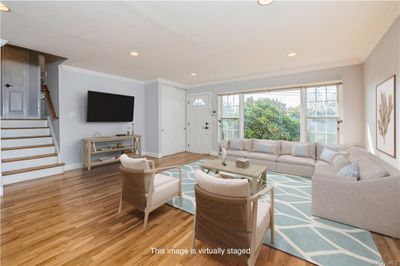 living room with ornamental molding and light wood-type flooring | Image 3