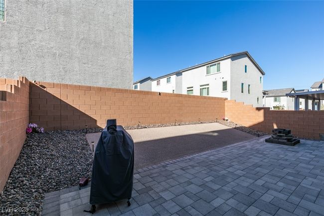 View of patio / terrace with a fenced backyard, a residential view, and grilling area | Image 39