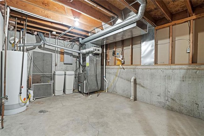 Unfinished basement featuring gas water heater, heating unit, and a water softener system | Image 35