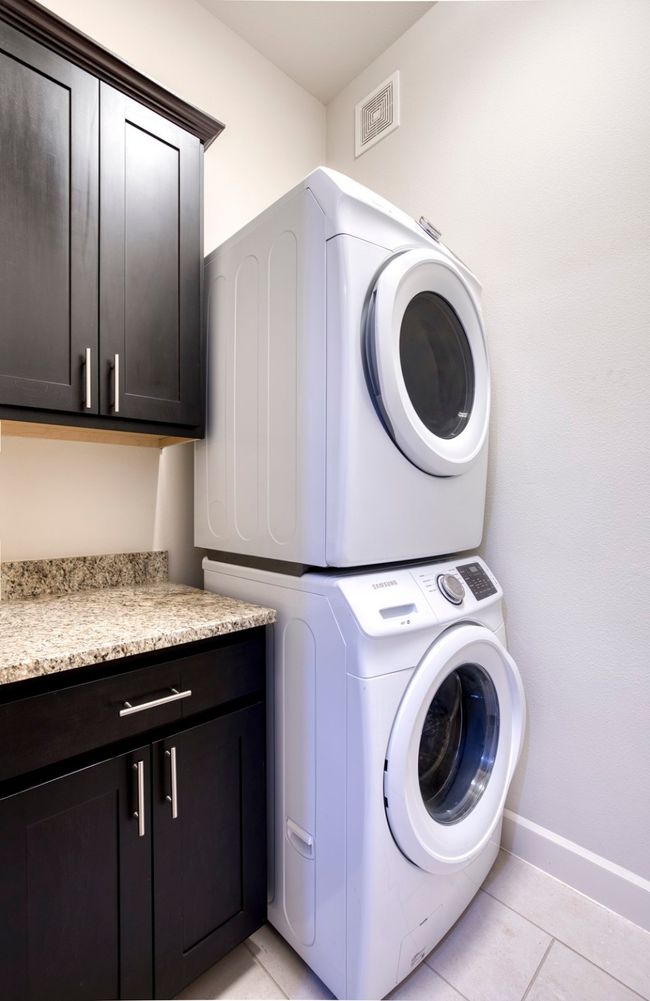 Laundry room with cabinetry and granite counter. | Image 23